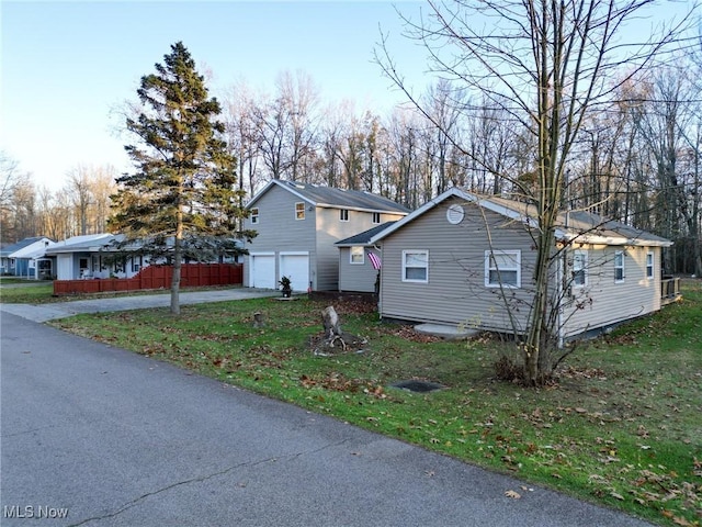 5192 University Dr, Geneva, OH 44041 - view of property exterior with driveway, an attached garage, and a yard