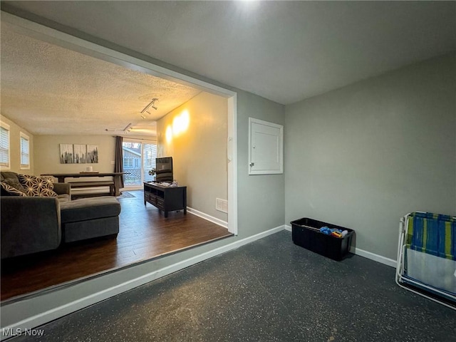 5192 University Dr, Geneva, OH 44041 - living area featuring a textured ceiling and baseboards