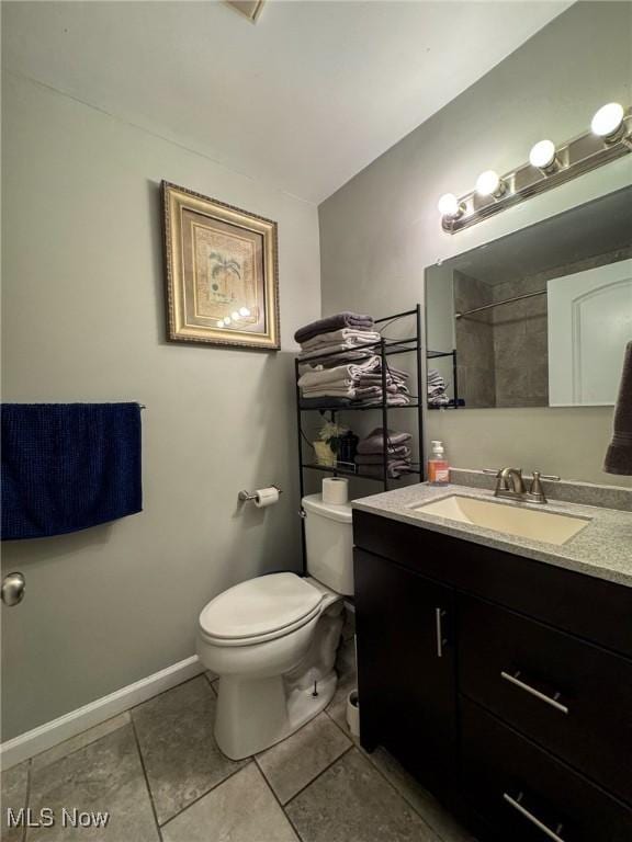 5192 University Dr, Geneva, OH 44041 - full bath with baseboards, toilet, lofted ceiling, tile patterned flooring, and vanity