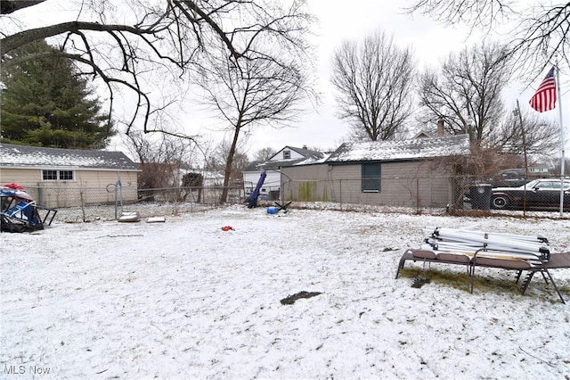 snowy yard with fence