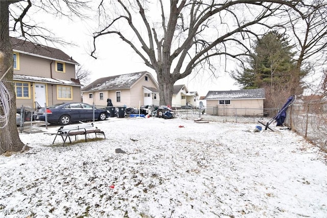 yard layered in snow featuring a fenced backyard