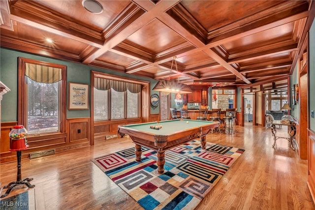 game room with wood finished floors, a wainscoted wall, coffered ceiling, beam ceiling, and pool table