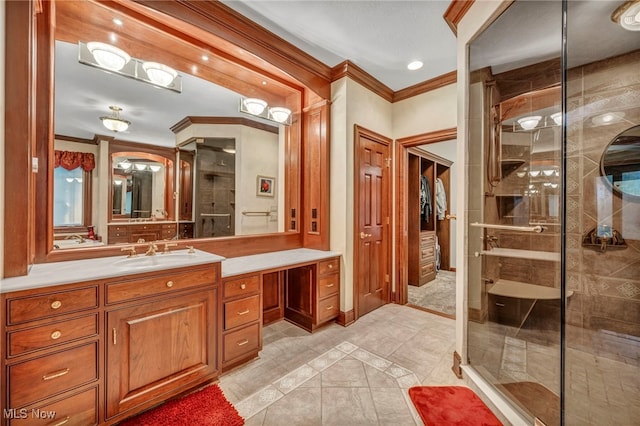 full bathroom with vanity, a shower stall, and crown molding