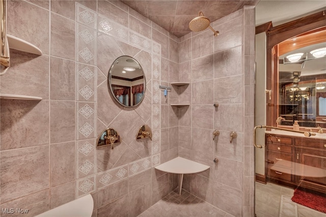 full bathroom featuring vanity and a tile shower