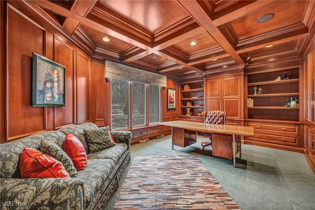 carpeted home office featuring built in shelves, coffered ceiling, wooden ceiling, and wooden walls