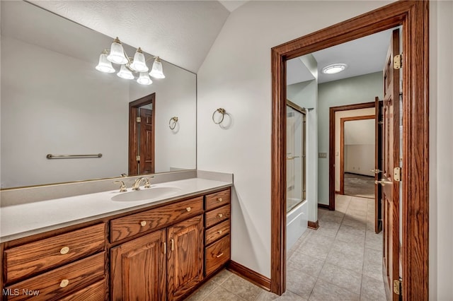 full bath featuring baseboards, vanity, vaulted ceiling, tile patterned floors, and washtub / shower combination