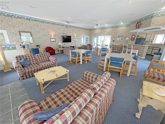 carpeted living room with ceiling fan and wallpapered walls