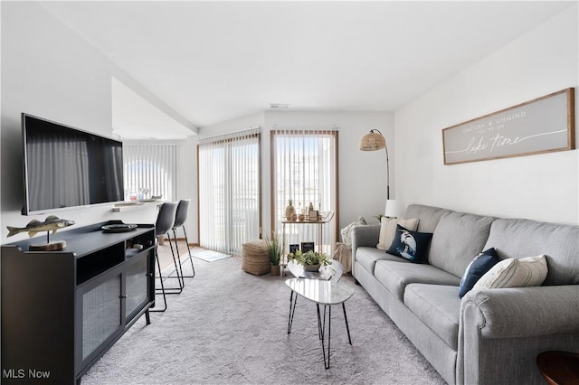 carpeted living room featuring visible vents