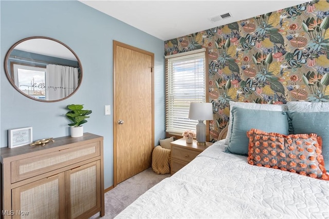 bedroom with light colored carpet and visible vents