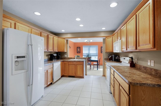 kitchen with white appliances, light tile patterned floors, a peninsula, an inviting chandelier, and recessed lighting