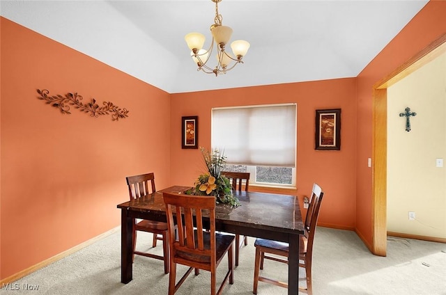 dining room featuring a chandelier, baseboards, and light colored carpet