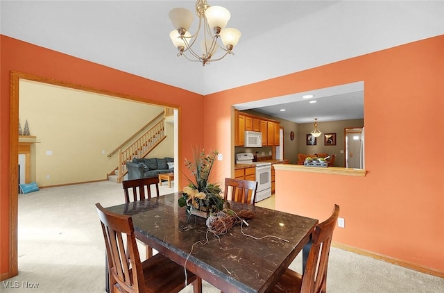 dining space featuring light carpet, stairway, a notable chandelier, and baseboards