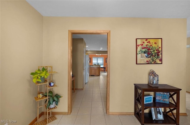 hall with light tile patterned floors and baseboards