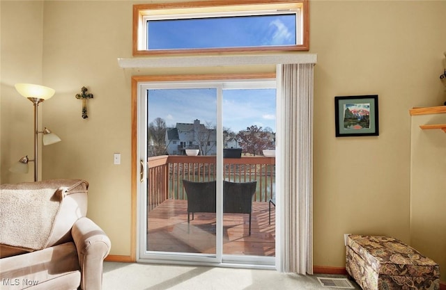 entryway featuring carpet, visible vents, and baseboards