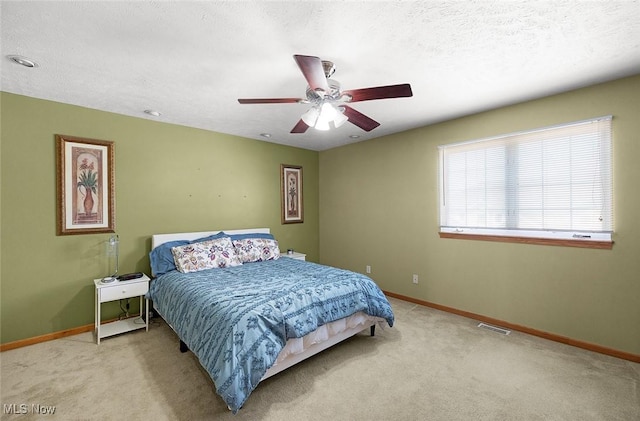 bedroom with carpet, visible vents, and baseboards