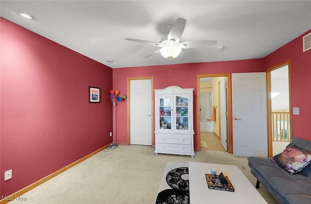 unfurnished living room featuring light carpet, visible vents, baseboards, and a ceiling fan