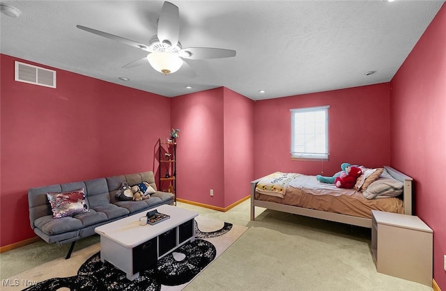 carpeted bedroom with baseboards, visible vents, and a ceiling fan