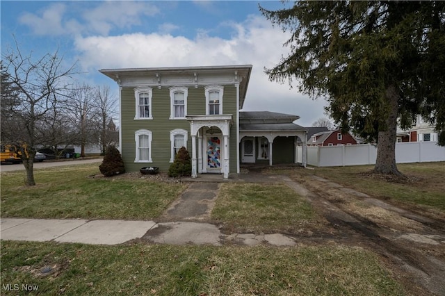 italianate house with fence and a front yard