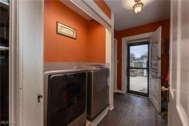 laundry area featuring dark wood-style floors, washing machine and dryer, and laundry area