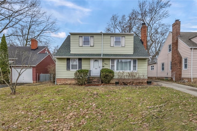 view of front of property with a garage, roof with shingles, a chimney, and a front lawn