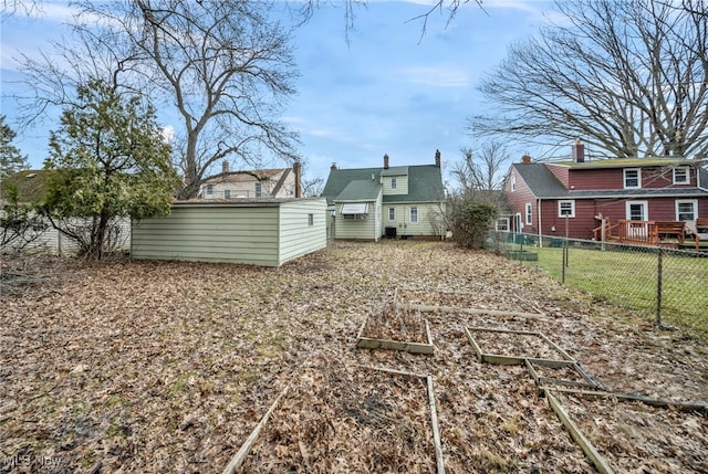 view of yard with a vegetable garden and fence