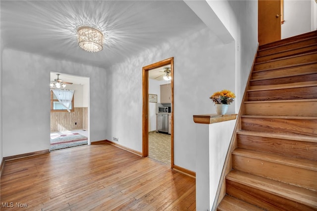 stairway featuring visible vents, hardwood / wood-style flooring, and baseboards