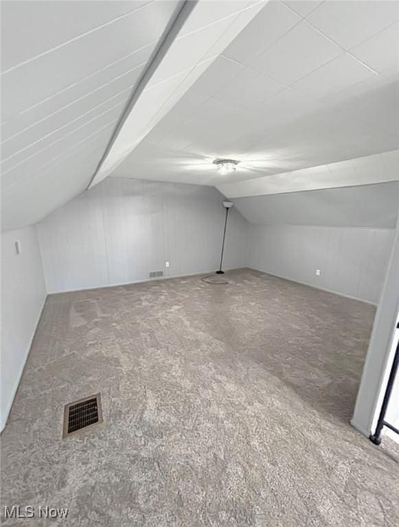 bonus room with lofted ceiling and visible vents