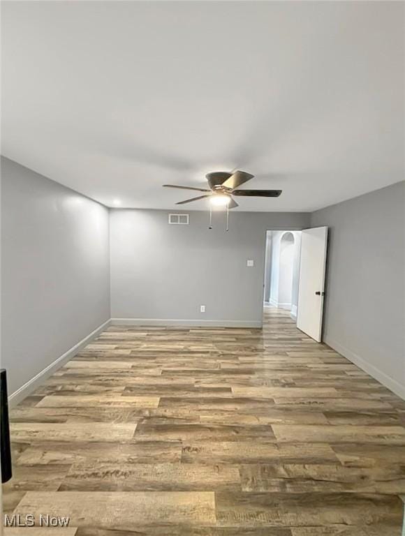 unfurnished room with visible vents, baseboards, and wood finished floors