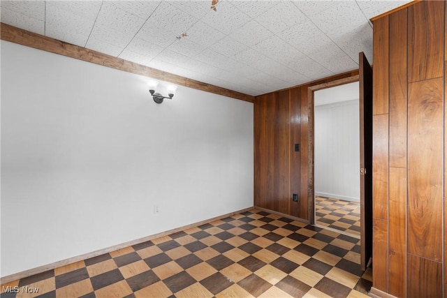 empty room featuring wood walls