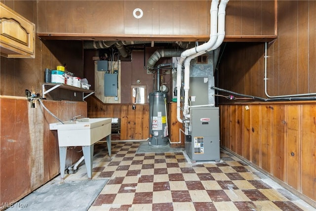 utility room featuring water heater and electric panel