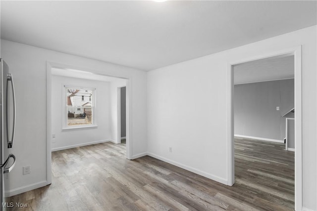 empty room featuring baseboards and wood finished floors