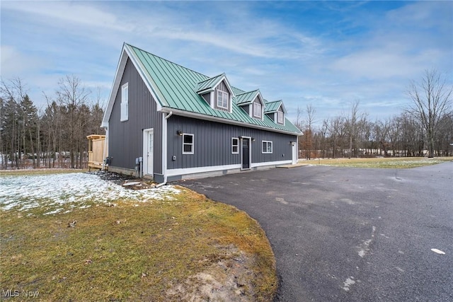 view of side of property with metal roof and a standing seam roof