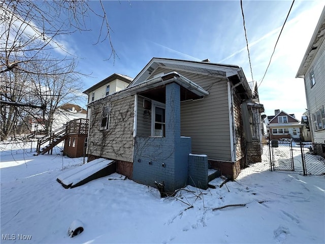 view of front facade with a garage, fence, and a gate