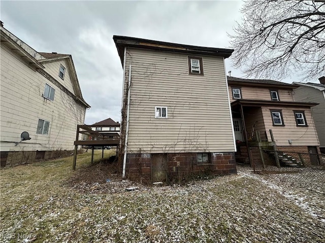 rear view of house with a wooden deck