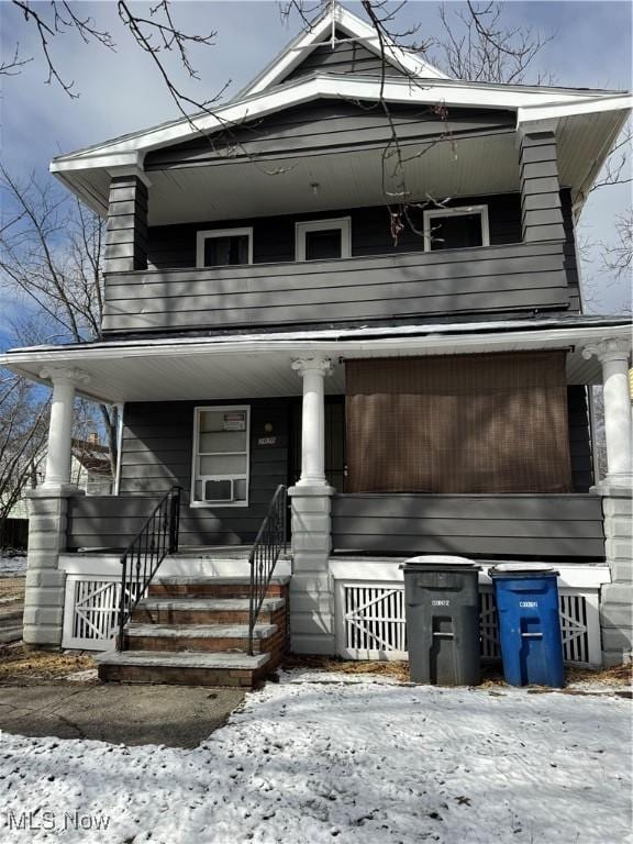 view of front facade with a balcony and a porch