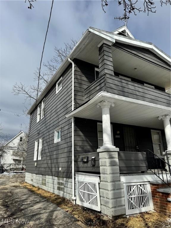 view of side of home featuring a balcony