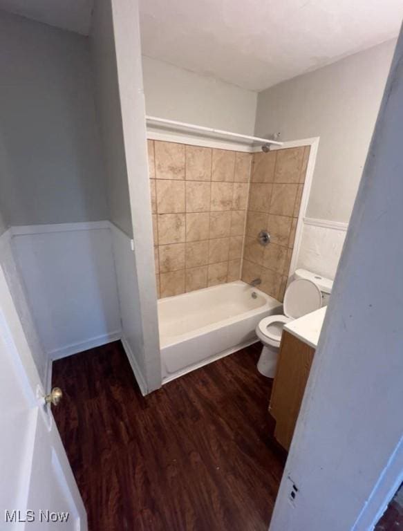 full bathroom with shower / bathing tub combination, vanity, toilet, and wood finished floors