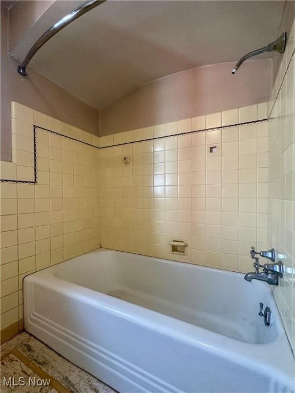 bathroom with bathing tub / shower combination