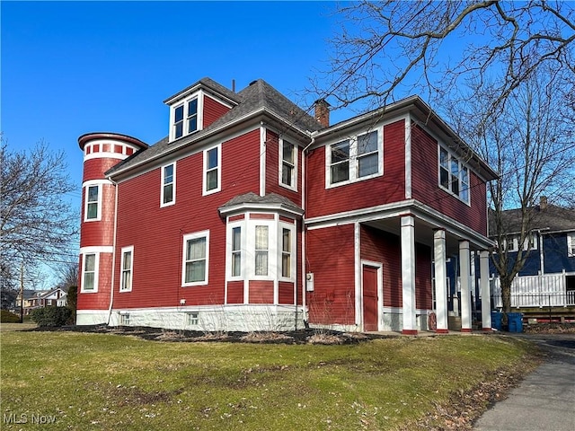 view of property exterior with a lawn and a chimney