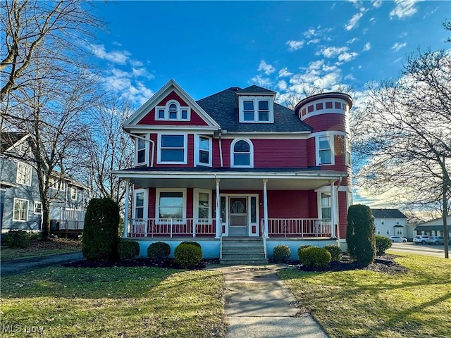 victorian home with a porch and a front yard