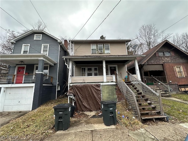 view of front of home featuring an attached garage, driveway, stairway, and a porch