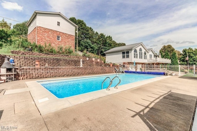 view of pool featuring a patio, fence, and a fenced in pool