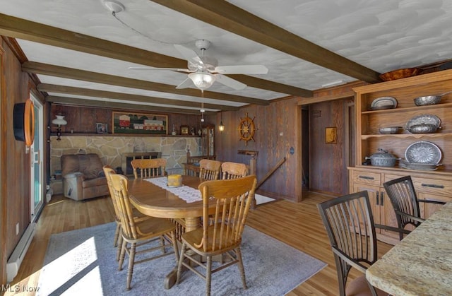 382 E Mohawk Dr, Malvern, OH 44644 - dining room featuring wood walls, beamed ceiling, light wood-style floors, and ceiling fan