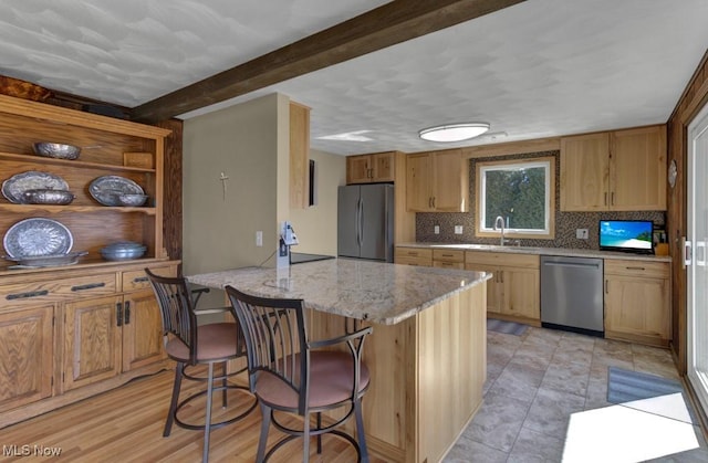 382 E Mohawk Dr, Malvern, OH 44644 - kitchen featuring stainless steel appliances, a breakfast bar area, a sink, beam ceiling, and light stone countertops