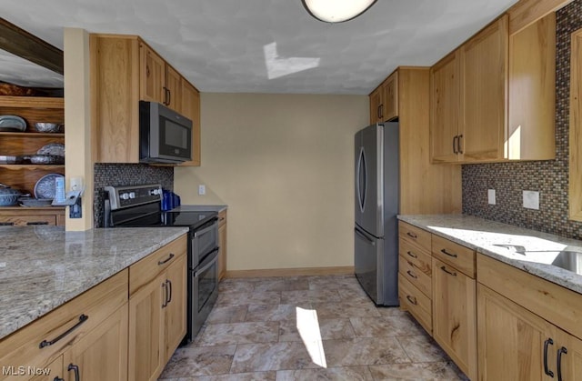 382 E Mohawk Dr, Malvern, OH 44644 - kitchen featuring appliances with stainless steel finishes, tasteful backsplash, light stone counters, and baseboards