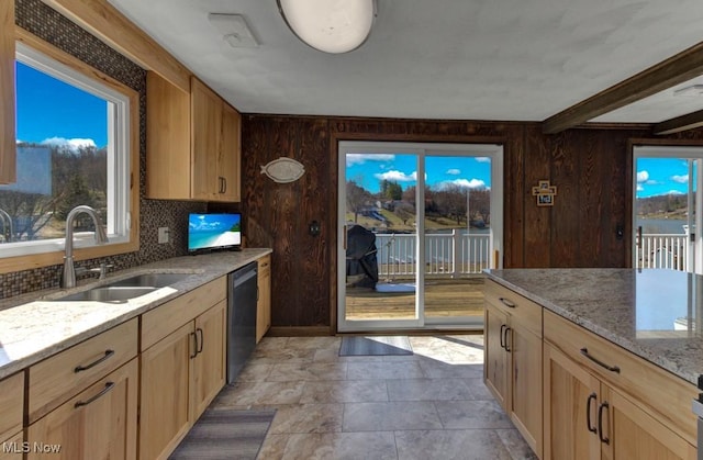 382 E Mohawk Dr, Malvern, OH 44644 - kitchen with a sink, dishwasher, light brown cabinetry, light stone counters, and wooden walls