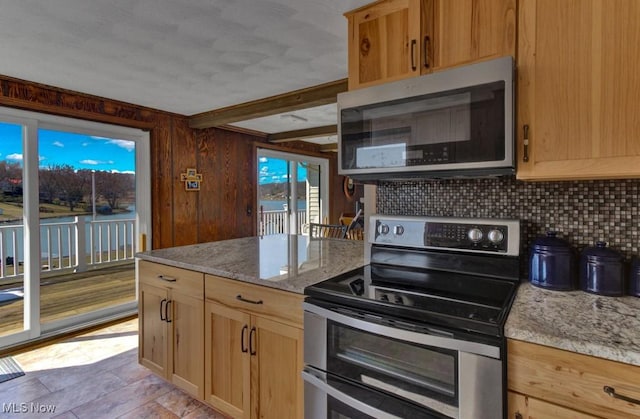 382 E Mohawk Dr, Malvern, OH 44644 - kitchen featuring stainless steel appliances, tasteful backsplash, light stone counters, a peninsula, and beamed ceiling