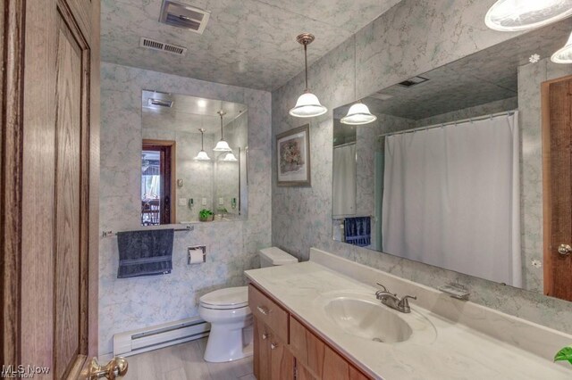 382 E Mohawk Dr, Malvern, OH 44644 - bathroom with baseboard heating, toilet, vanity, wood finished floors, and a shower with curtain