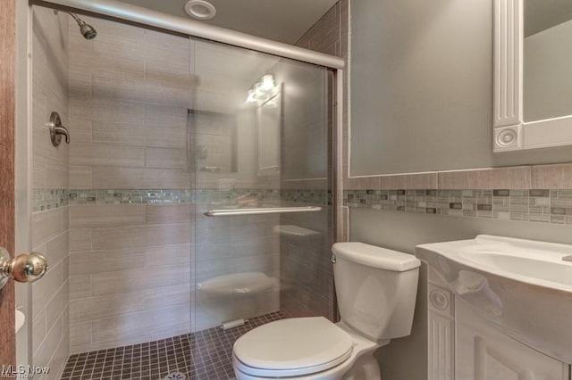 382 E Mohawk Dr, Malvern, OH 44644 - full bath with toilet, a stall shower, tile walls, vanity, and a wainscoted wall