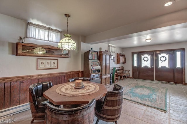 382 E Mohawk Dr, Malvern, OH 44644 - dining space with plenty of natural light, a wainscoted wall, tile patterned flooring, and wood walls